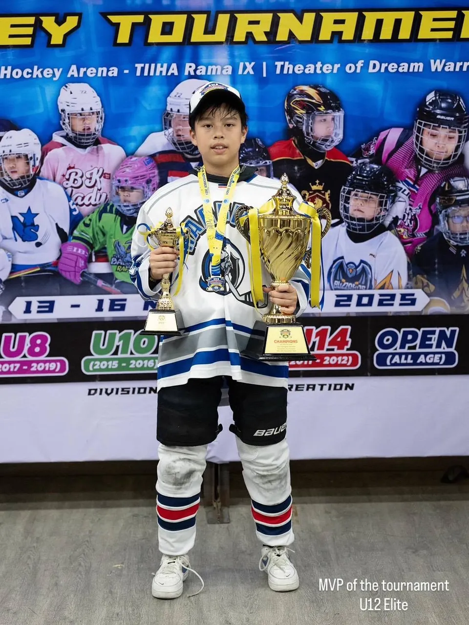 Young Underdogs ice hockey athlete holding two tournament trophies, Body By Beast Bangkok